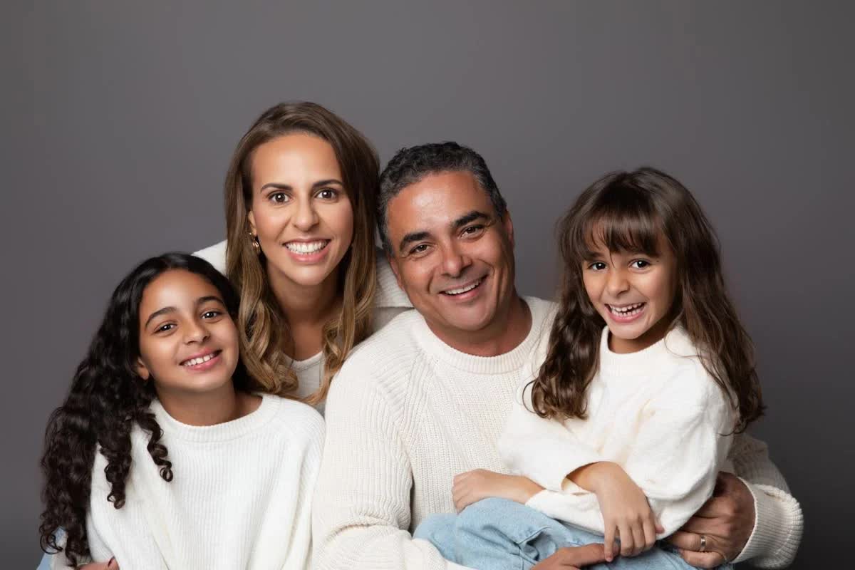 The Coelho family smiling together